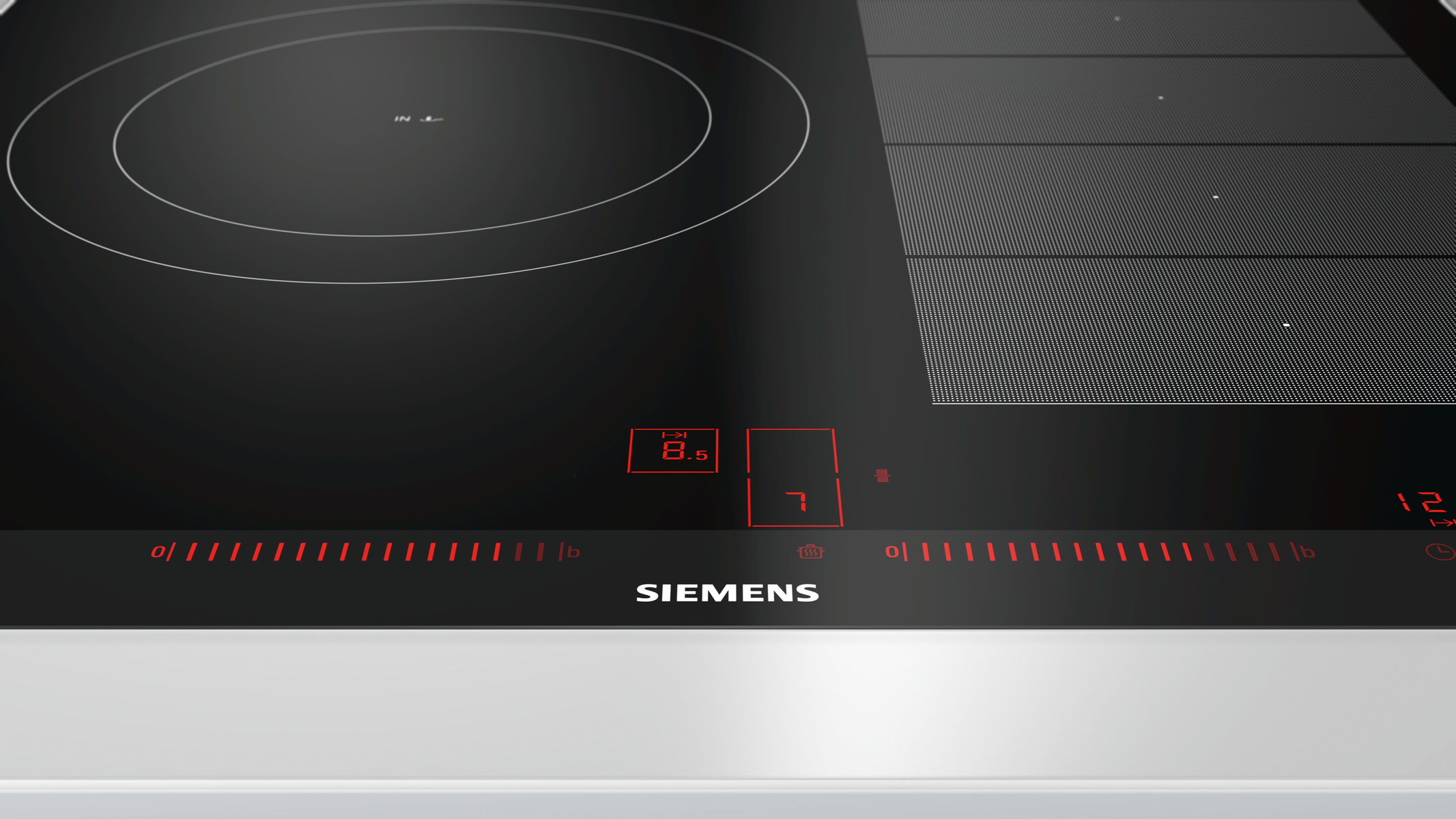 Primer plano de placa Siemens negra con pantalla digital roja y controles táctiles.