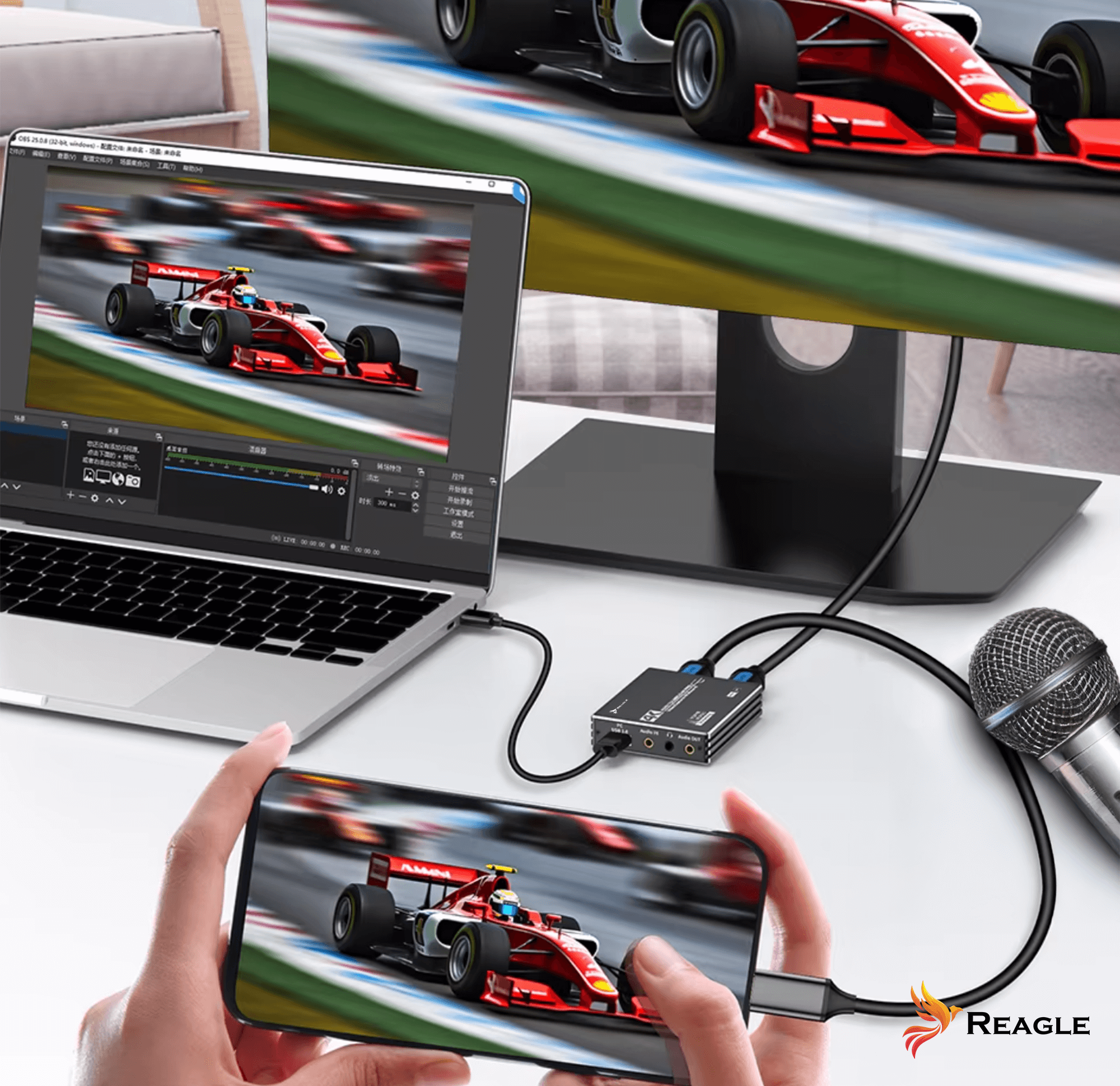 Laptop podłączony do monitora i telefonu transmitującego wyścigi. Mikrofon i urządzenie Reagle znajdują się w scenie.
