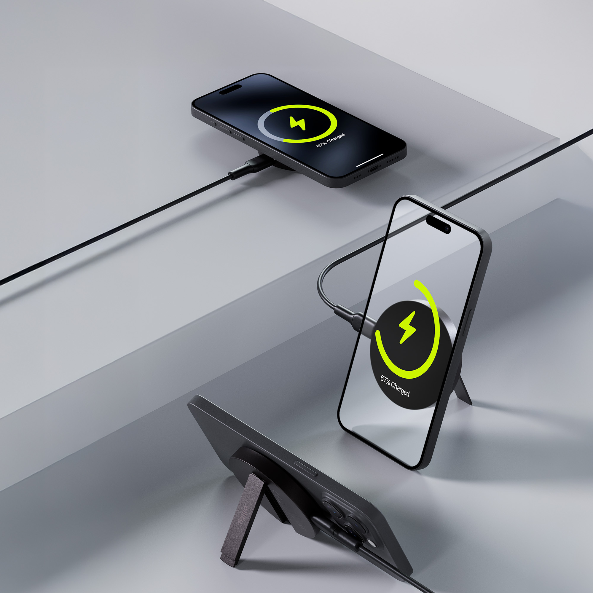 Trzy czarne telefony ładujące się bezprzewodowo, jeden pokazuje 67% naładowania.