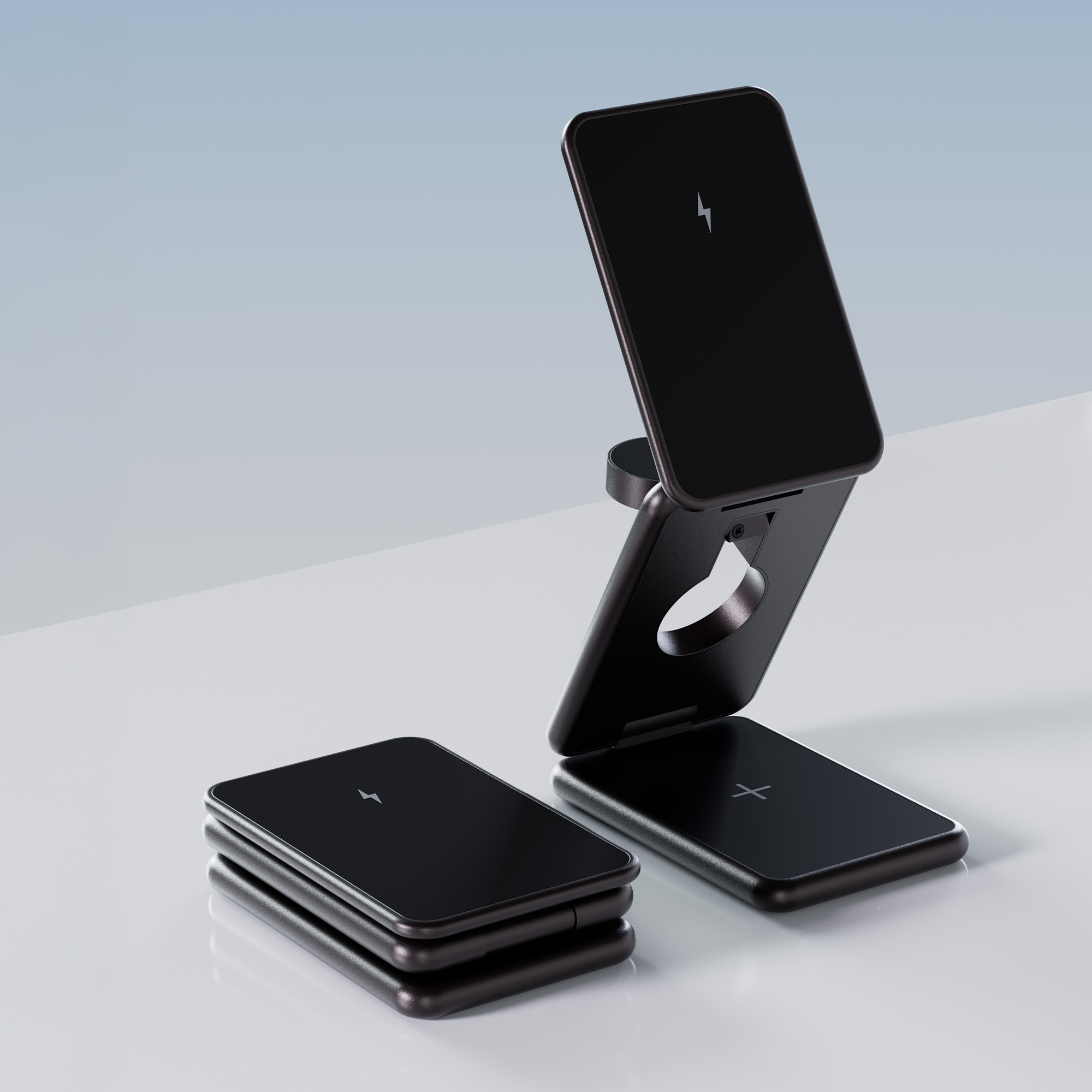 Dwie czarne ładowarki bezprzewodowe, jedna złożona i jedna rozłożona, na białej powierzchni.