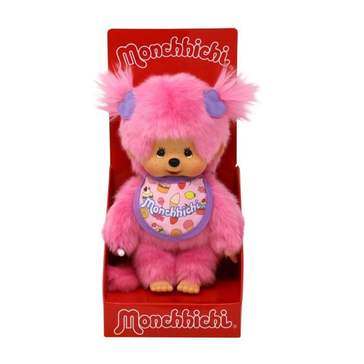 Rosa Monchhichi-Puppe in einer roten Box. Sie trägt ein Lätzchen. Der Hintergrund ist schlicht.