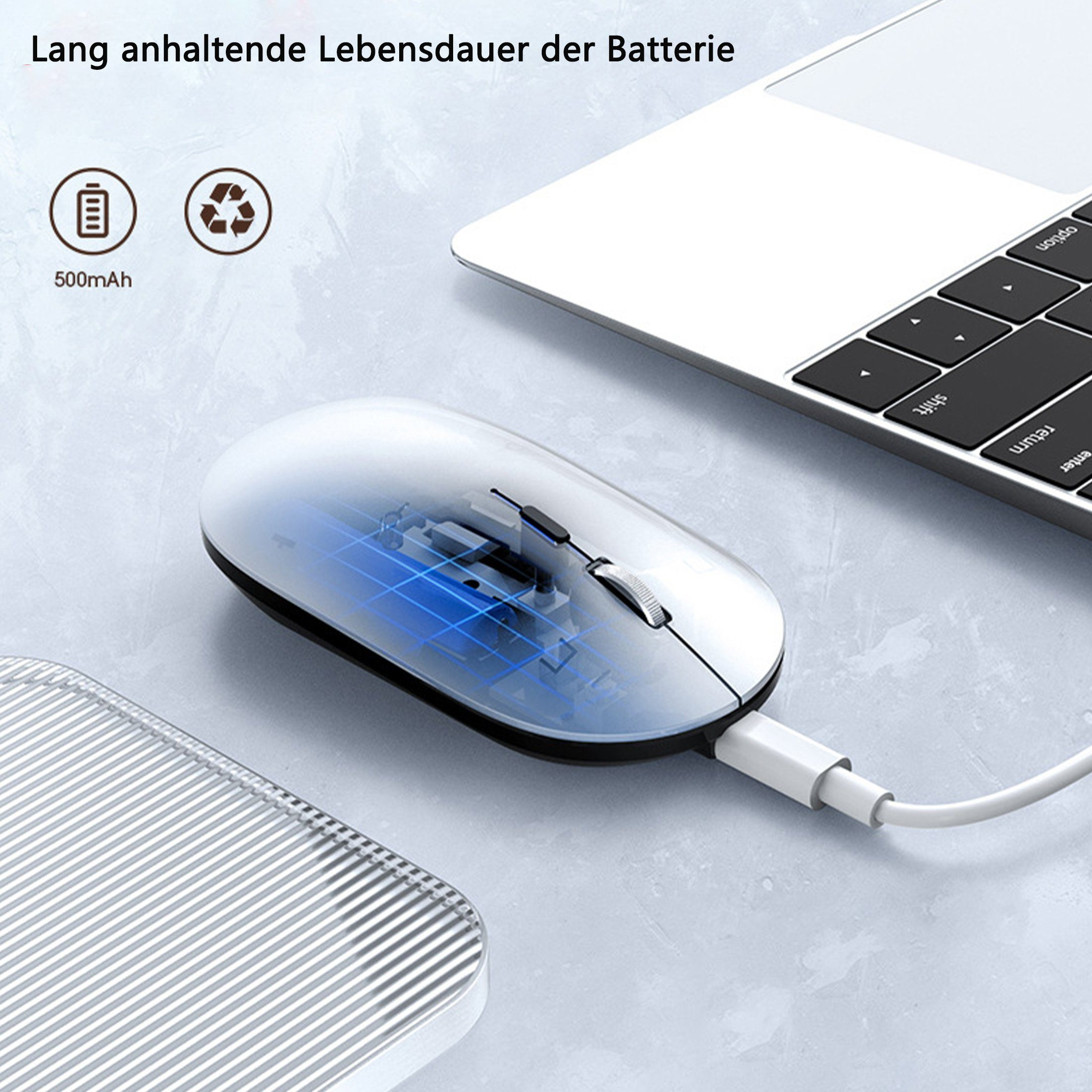 Eine weiße kabellose Maus mit einem Ladekabel neben einem Laptop.