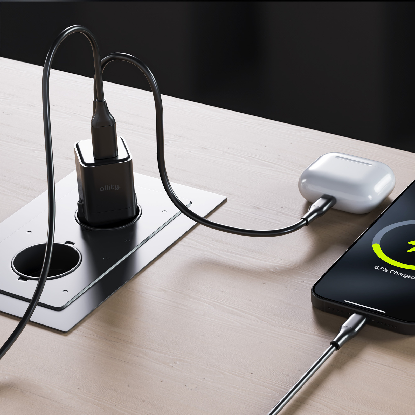 Konfiguracja ładowania z czarną ładowarką i kablem ładującym telefon i słuchawki.