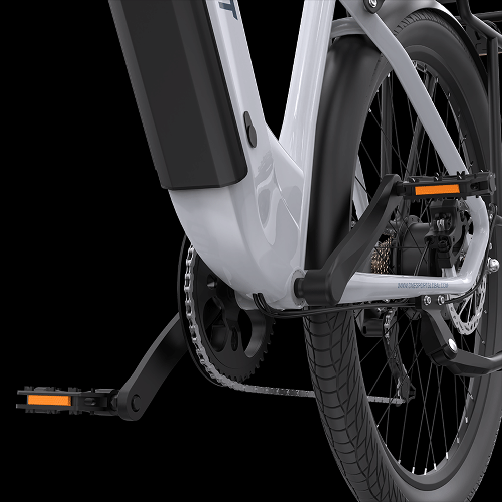 Primer plano de la rueda trasera y el área del pedal de una bicicleta eléctrica blanca.