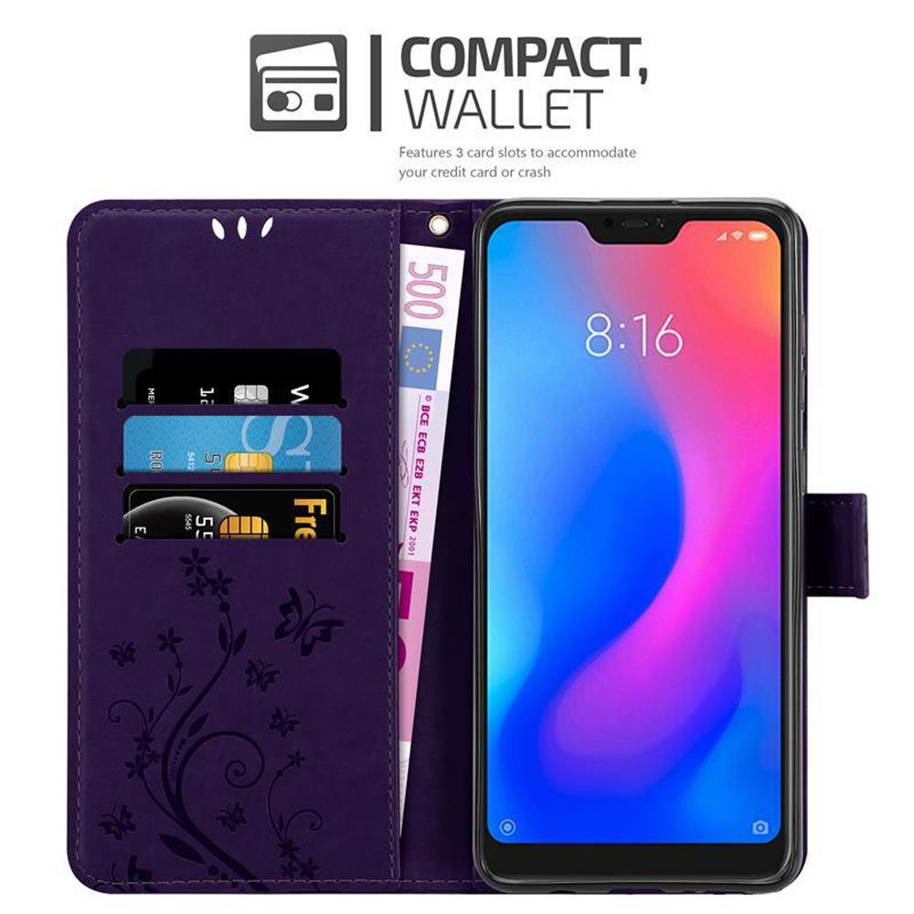 Una custodia per telefono viola aperta, che mostra un telefono, slot per schede e un vano per contanti.