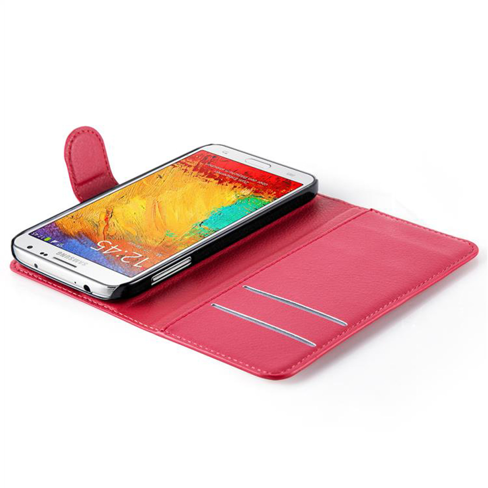 Eine rosa Handyhülle mit einem Telefon darin und einem weißen Hintergrund. Die Hülle ist offen.