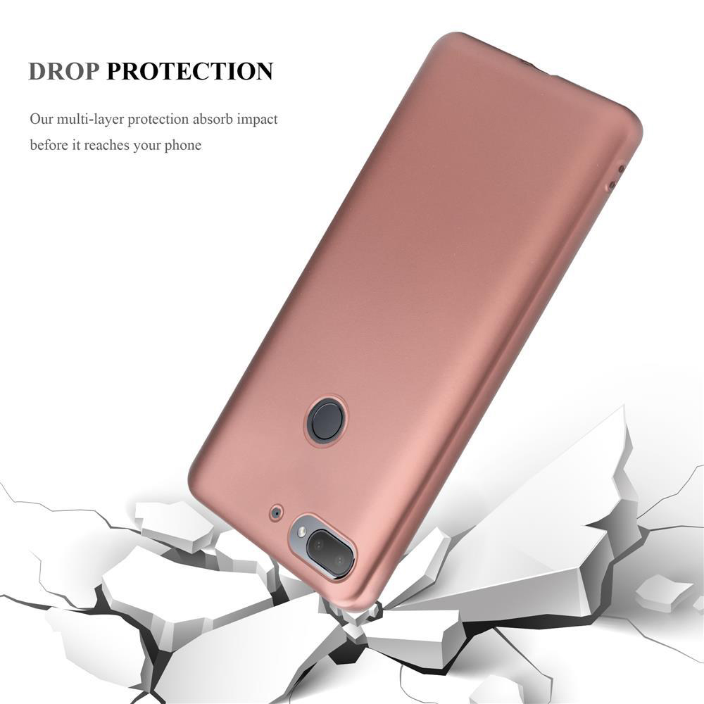 Custodia per telefono oro rosa con fotocamera e flash, sembra cadere su terreno crepato.