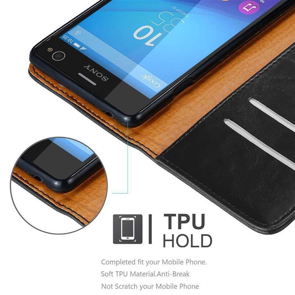 Telefono nero all'interno di una custodia marrone aperta. La custodia ha fessure per carte. Il telefono ha un display.