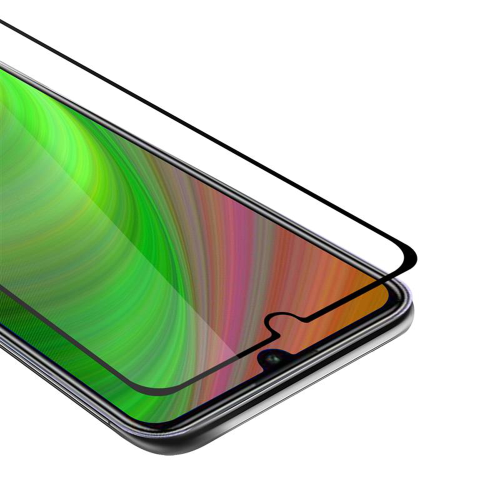 Uno smartphone con protezione schermo applicata. Il display mostra sfumature verdi, rosa e arancioni.