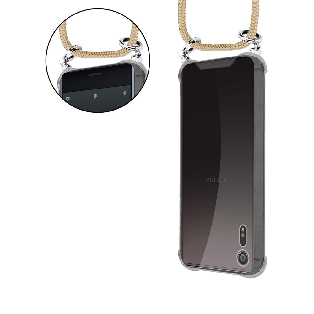 Telefono nero in una custodia trasparente con un cordino beige attaccato.