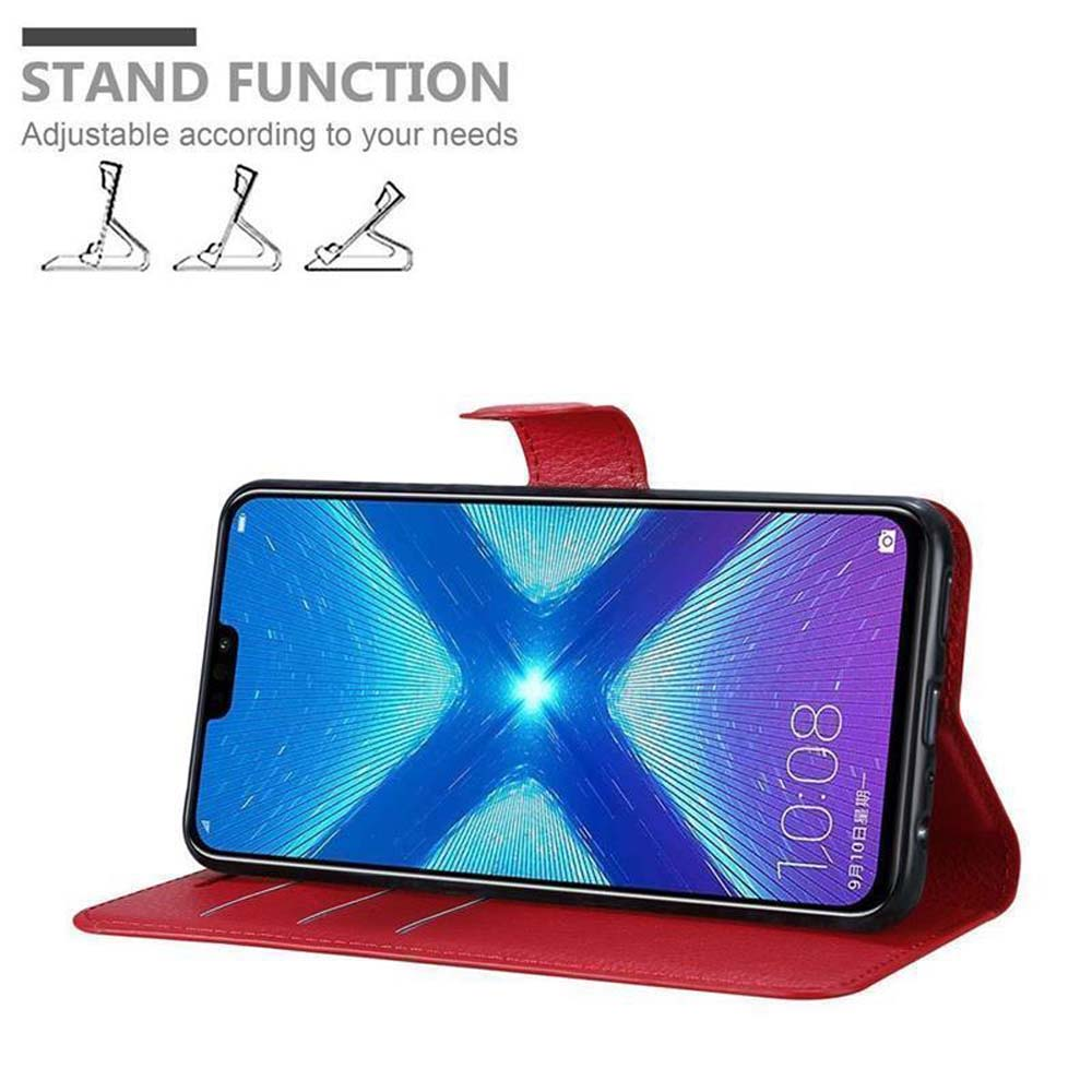 Telefono in custodia rossa, schermo mostra ora e data, appoggiato. Funzione stand con tre opzioni.