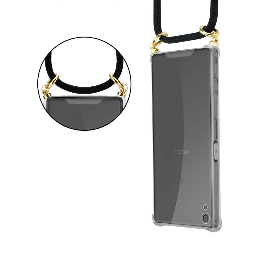 Ein Telefon in einer durchsichtigen Hülle mit einem Umhängeband. Die Hülle hat goldfarbene Ringe für das Band.