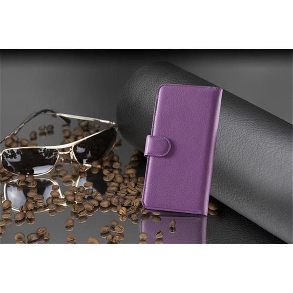 Eine lila Handyhülle mit einem Telefon darin, neben Sonnenbrille und Kaffeebohnen.