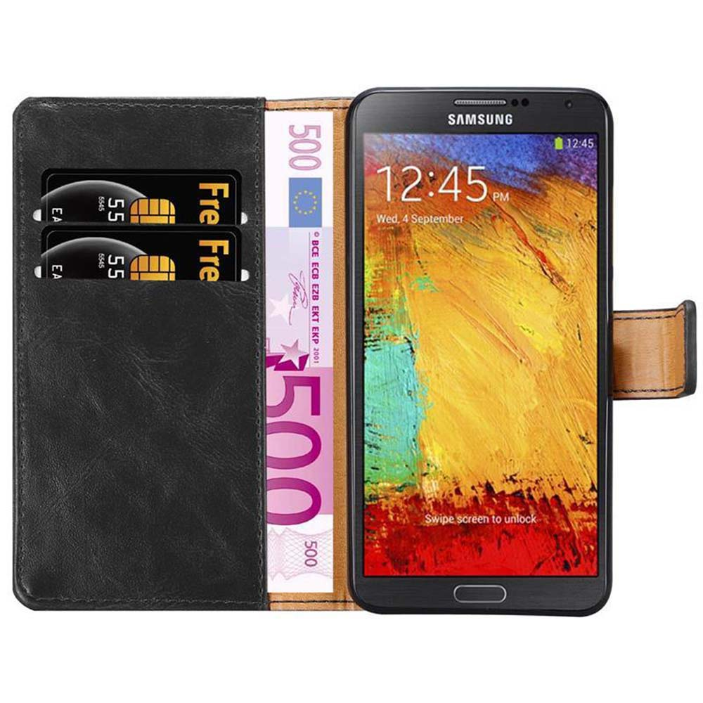 Funda negra con tarjetas y billete de 500 euros. Teléfono muestra la hora.