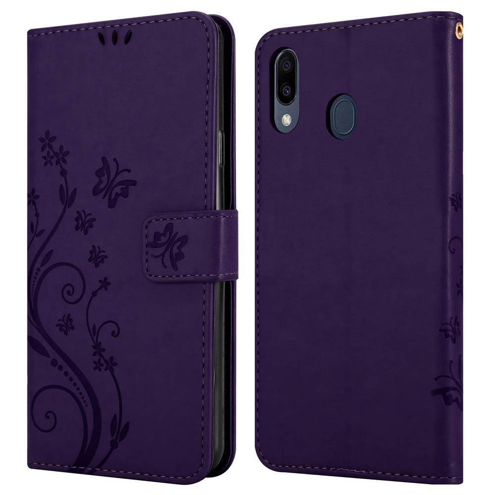 Custodia per telefono viola, aperta, che mostra il telefono. Decorata con un motivo floreale sul lato sinistro. Telefono all'interno.