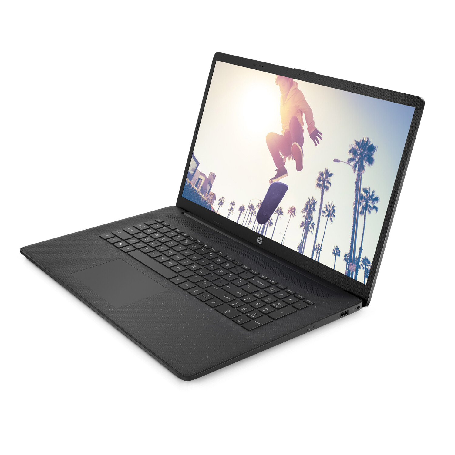 Laptop auf weißer Oberfläche mit Skateboarder auf dem Bildschirm, Palmen im Hintergrund.