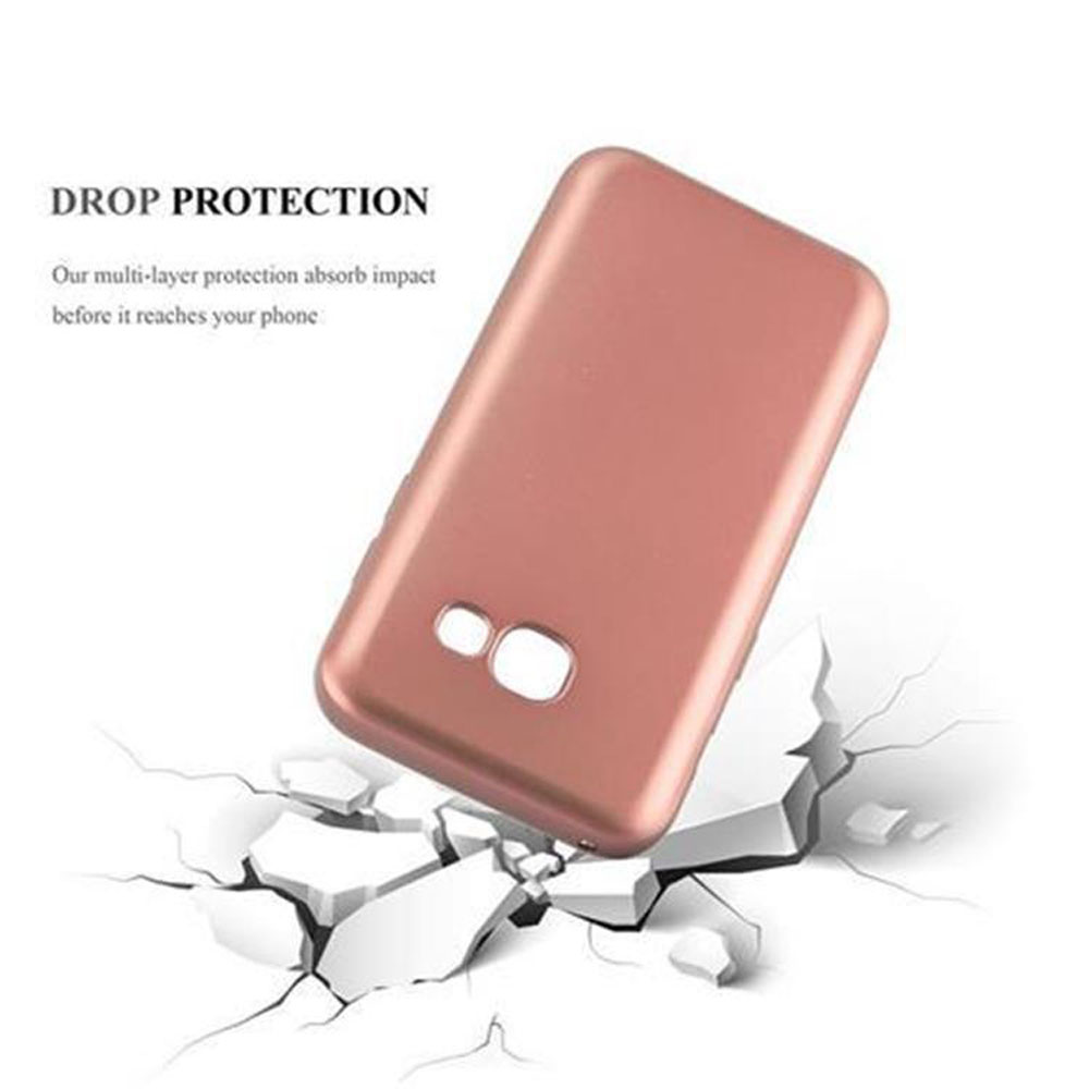 Una funda de teléfono oro rosa cae sobre hormigón blanco roto. El texto dice 'DROP PROTECTION'.