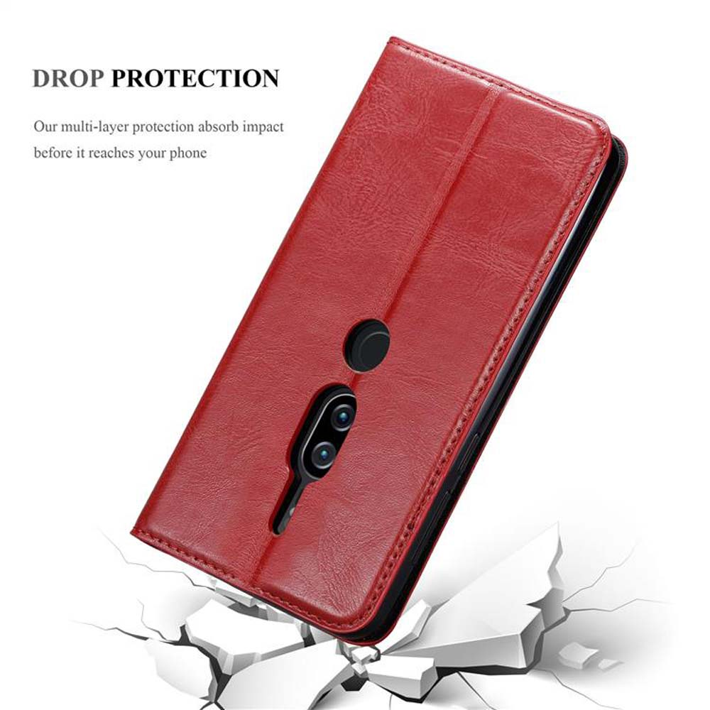 Custodia rossa per telefono, aperta, che mostra il telefono. Sotto, una superficie incrinata. Testo: Protezione anticaduta.