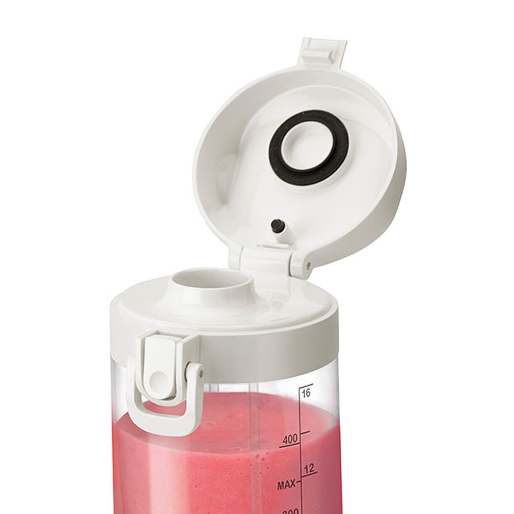 Un couvercle de mixeur, ouvert, avec un smoothie rose à l'intérieur. Couvercle blanc avec joint noir. Texte : '400'.