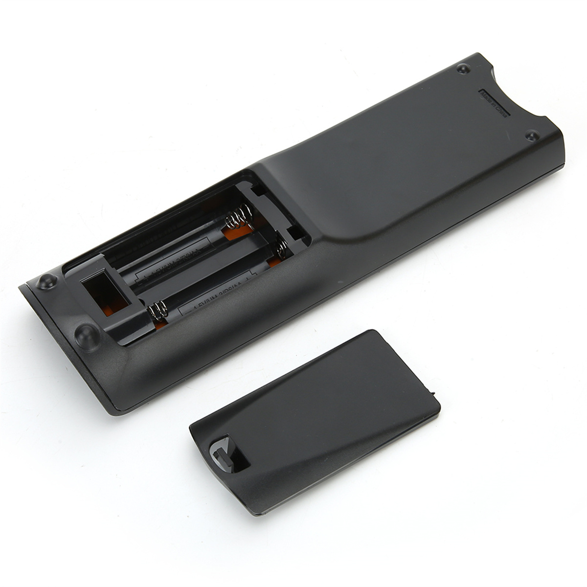Fernbedienung, geöffnet zur Anzeige der Batterien. Die Rückseite einer schwarzen Fernbedienung ist geöffnet.