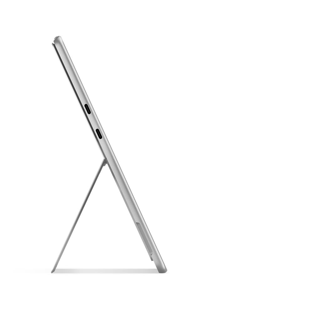 Srebrny tablet na białym tle, podparty. Widok z boku, pokazujący porty i podstawkę.