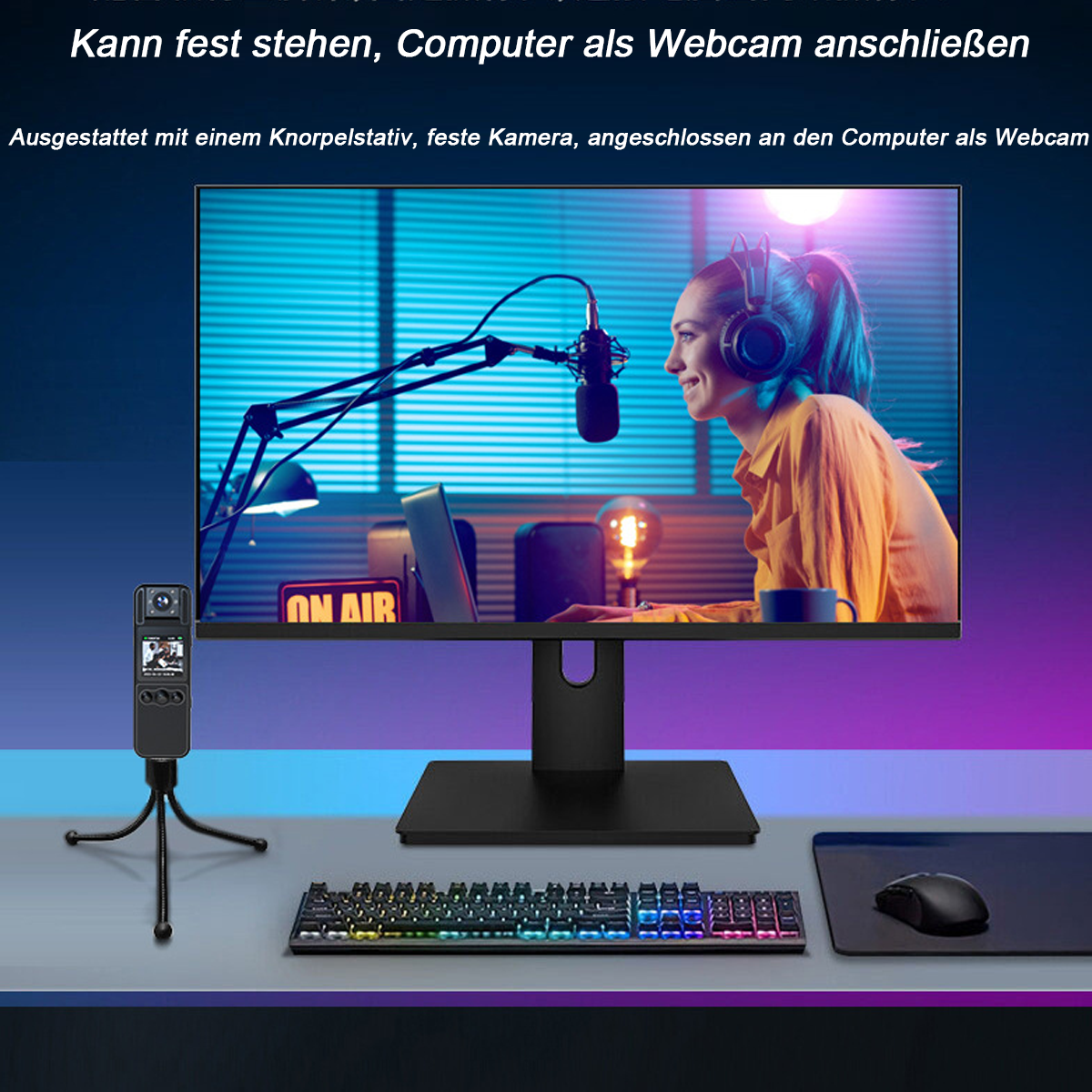 Ein Webcam-Setup mit Monitor, Tastatur, Maus und einer kleinen Kamera auf einem Stativ.