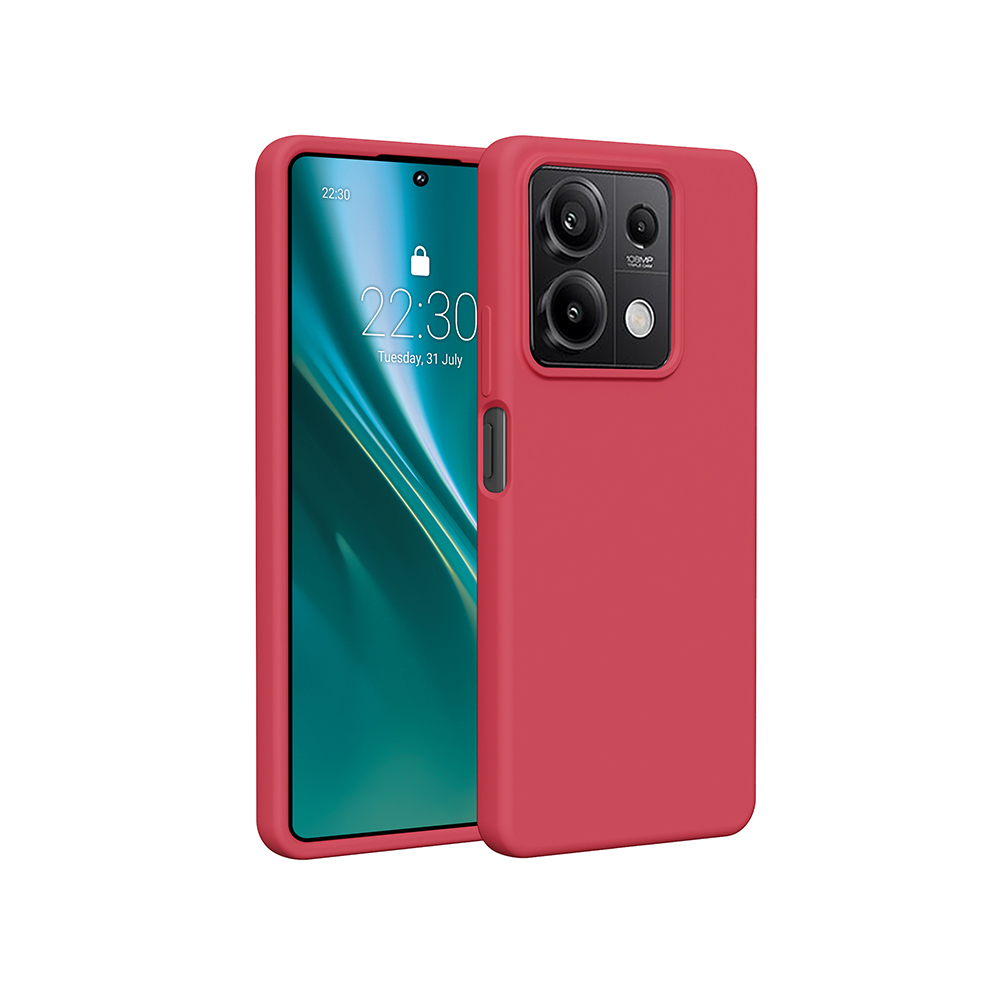 Un telefono rosso con una fotocamera. È seduto accanto a un altro telefono. Sfondo bianco.