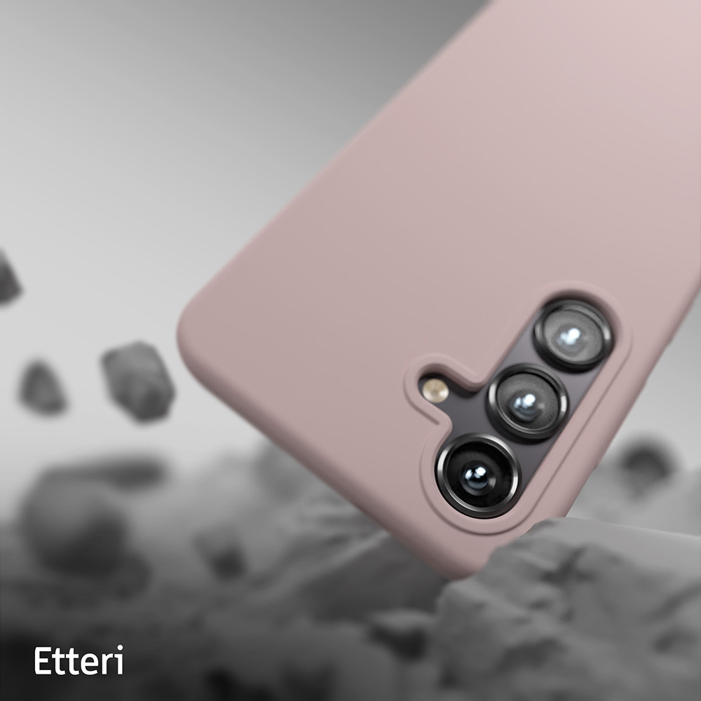 Custodia per telefono rosa con obiettivo della fotocamera. La custodia è su una superficie grigia e bianca.