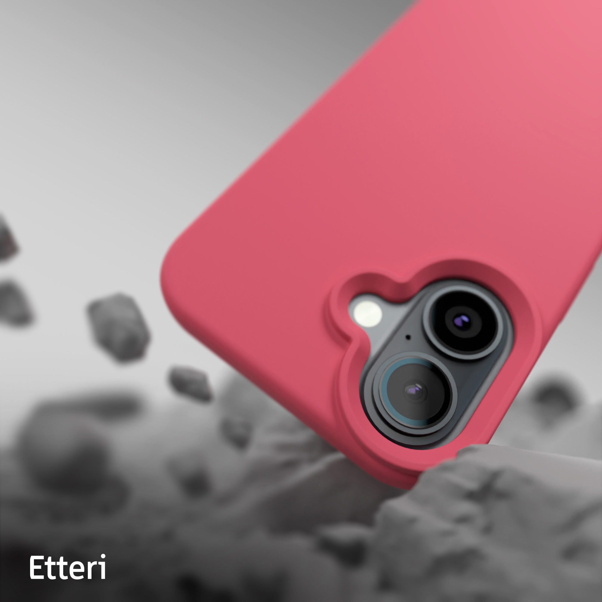 Un primo piano di una custodia rosa per telefono con lenti della fotocamera, su uno sfondo di pietre.