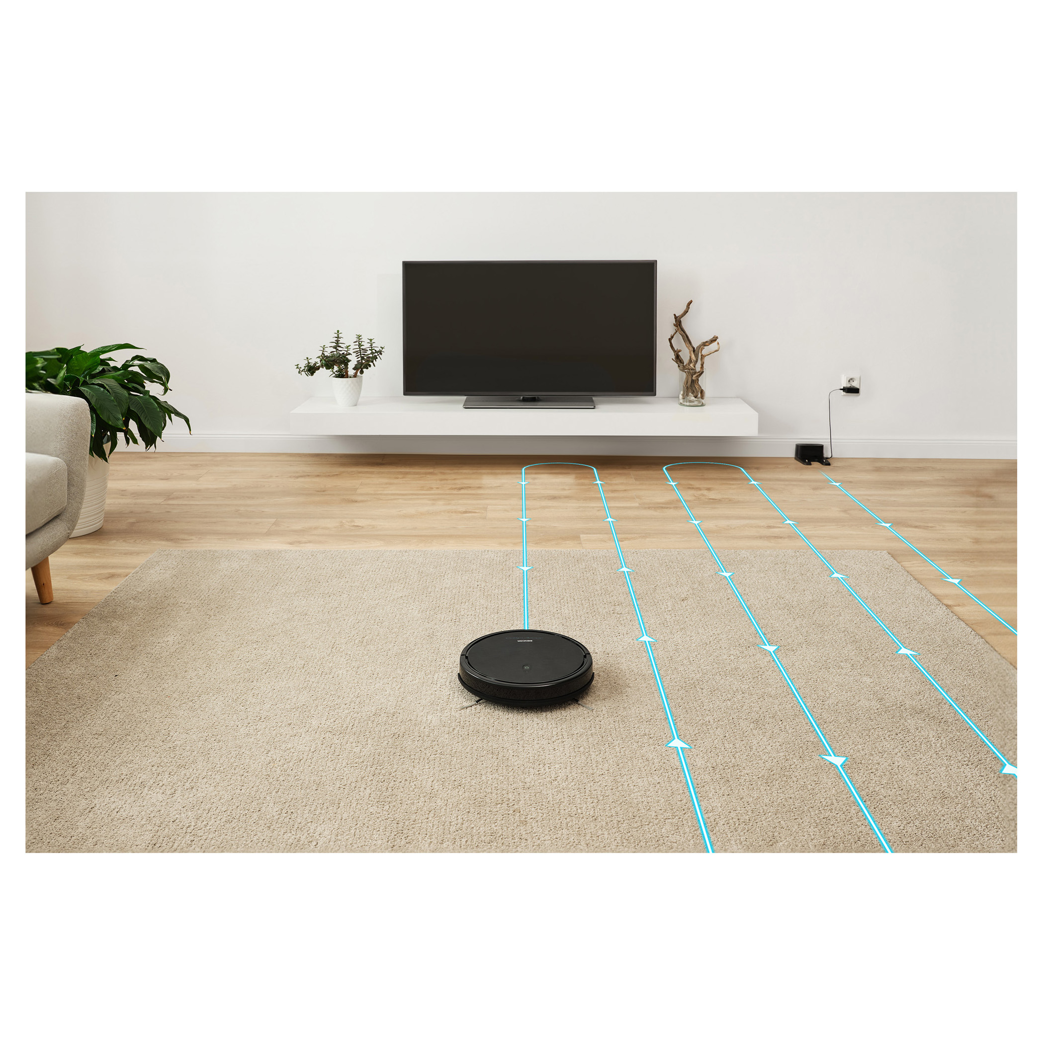 Robot vacuum cleaner cleaning a carpeted floor. The floor has a rug and the walls are white.