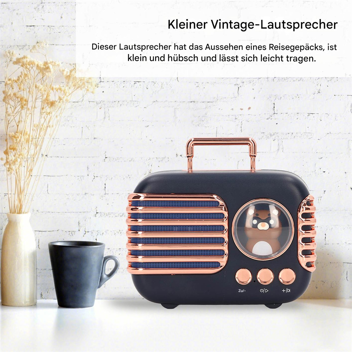 Ein Lautsprecher im Vintage-Stil mit einer pinguinförmigen Anzeige. Er hat einen schwarzen Körper mit kupferfarbenen Details.