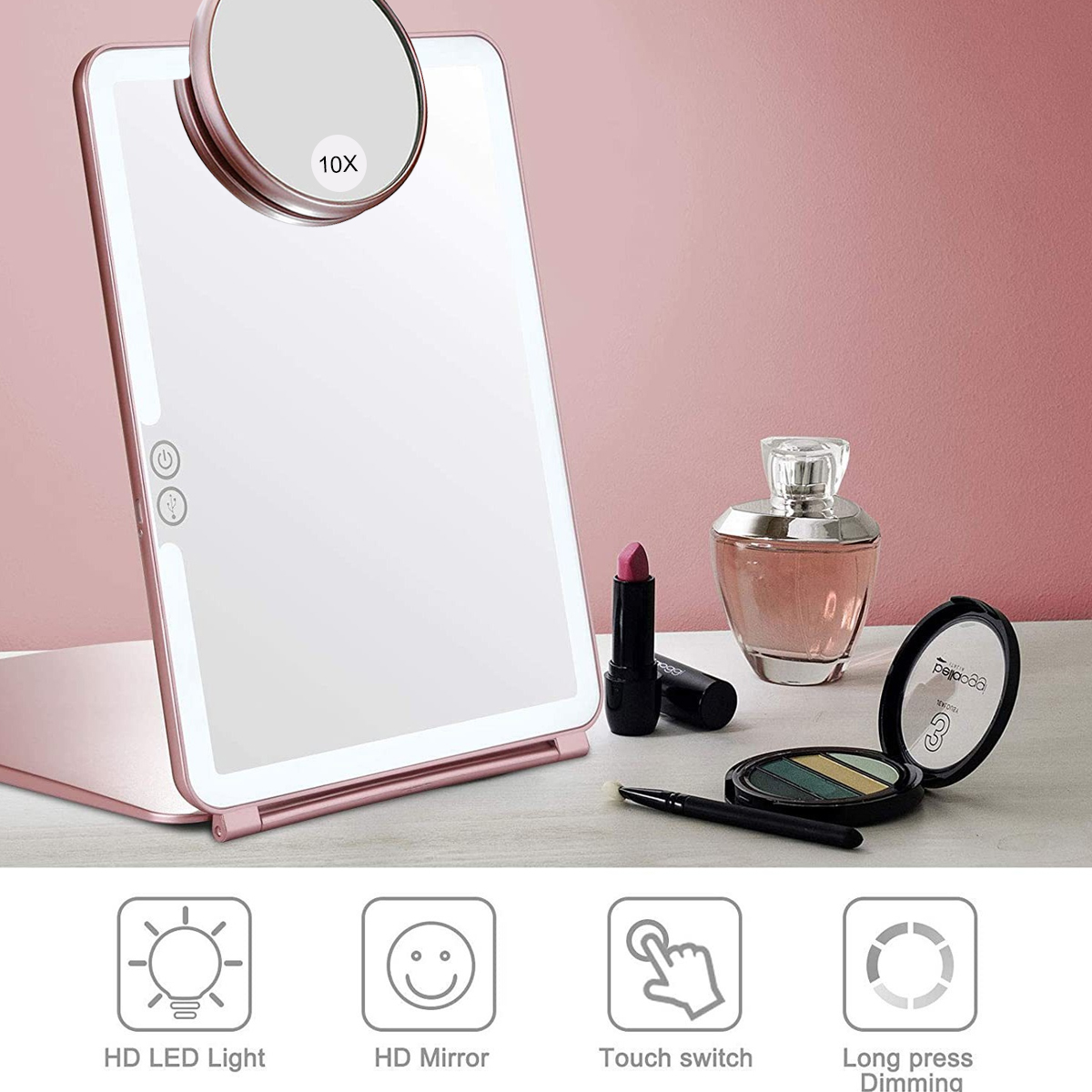 Ein pinkfarbener, faltbarer Schminkspiegel mit 10x Vergrößerungsspiegel, Lichtern und Make-up-Artikeln.