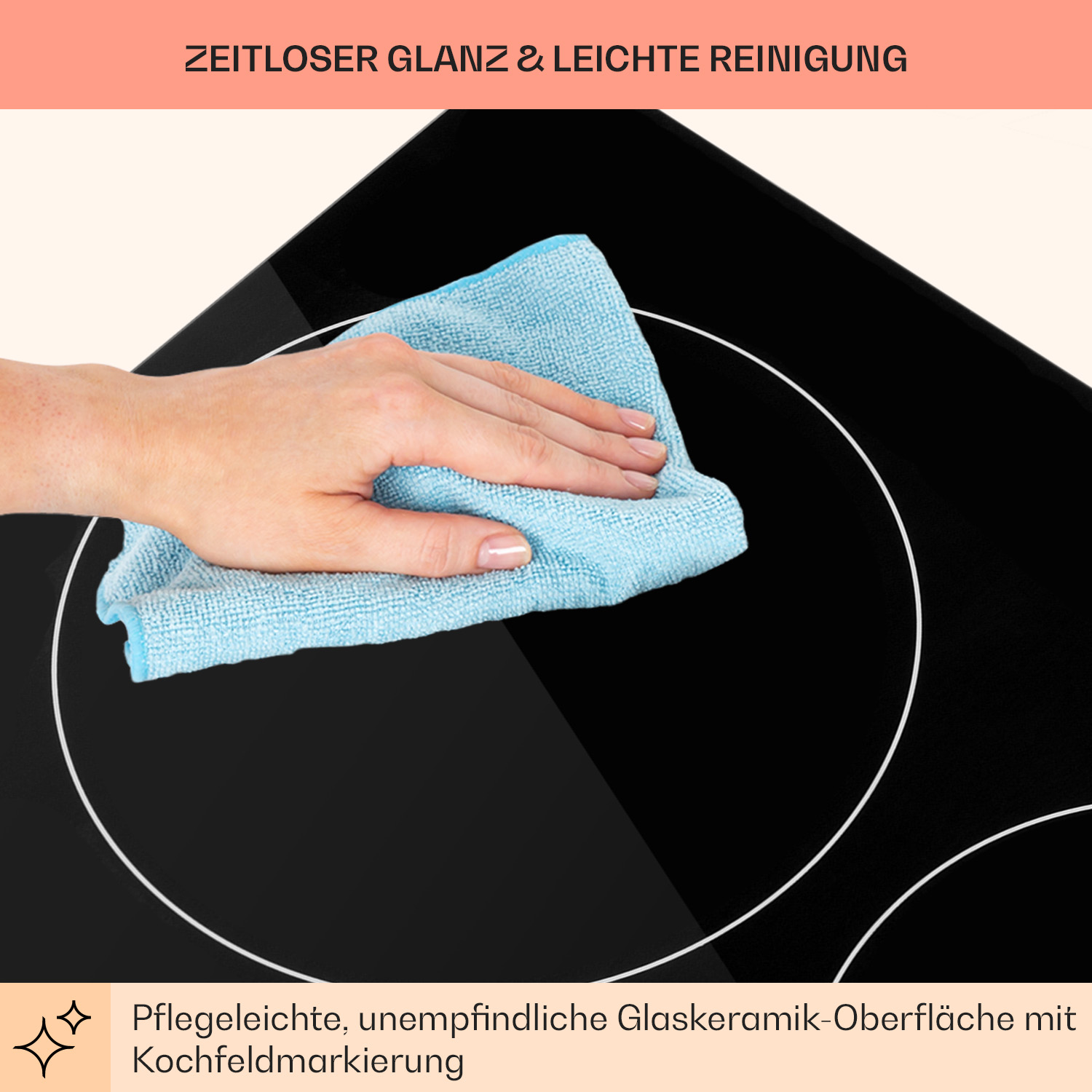Una mano pulisce un piano cottura in ceramica nero con un panno blu.