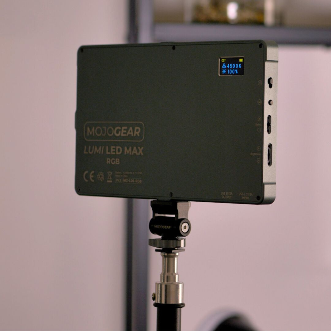 A black and silver LED light panel with a screen displaying settings, mounted on a stand.