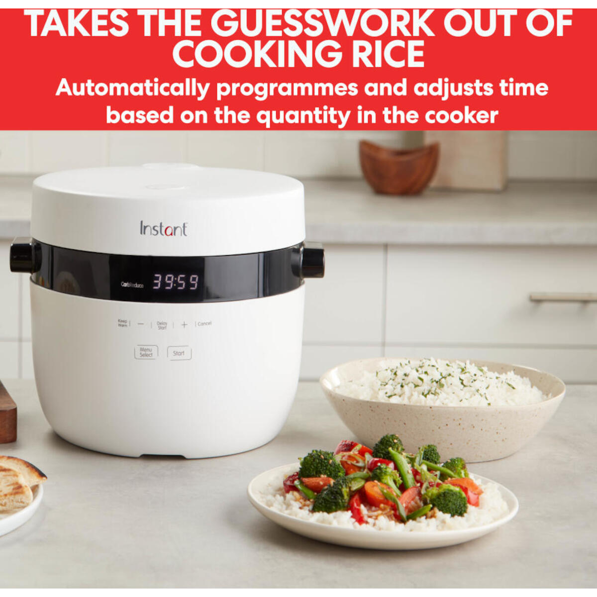 White rice cooker with a digital display, bowls of rice and vegetables are beside it.