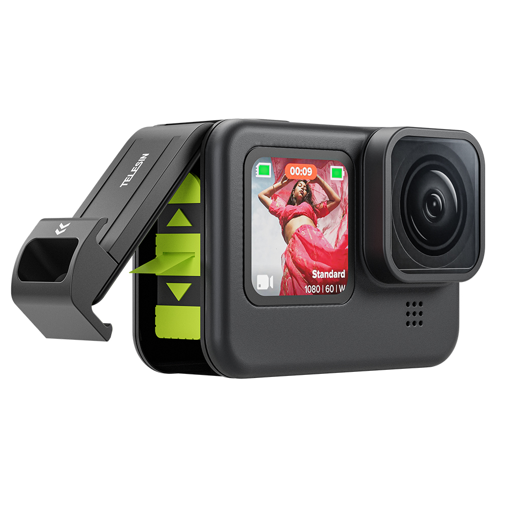 Een zwarte actiecamera met een scherm waarop een vrouw in een roze jurk staat, en een groene accessoire.