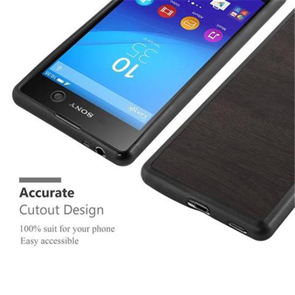 Smartphone negro con pantalla encendida, junto a una funda de teléfono de madera.