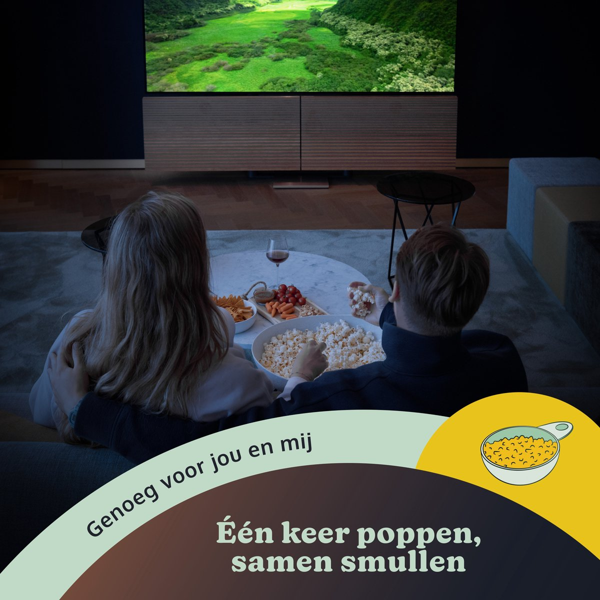 Couple watching TV, eating snacks. Popcorn, vegetables, and wine are visible. Text: Enough for you and me.