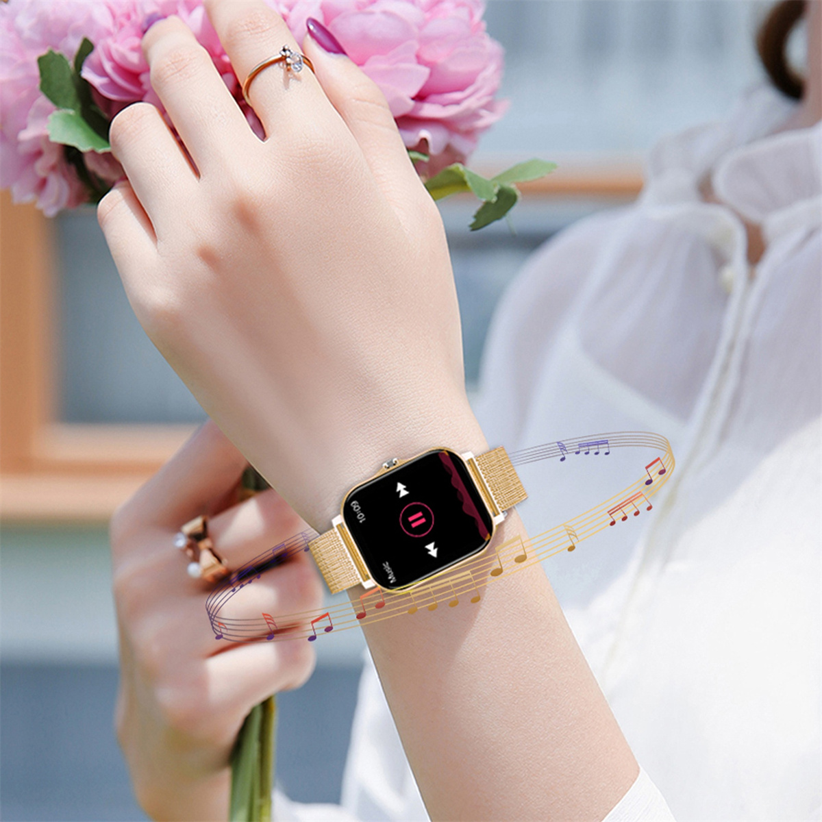 Handgelenk einer Frau mit goldener Smartwatch, Musiksteuerung; Blumen.