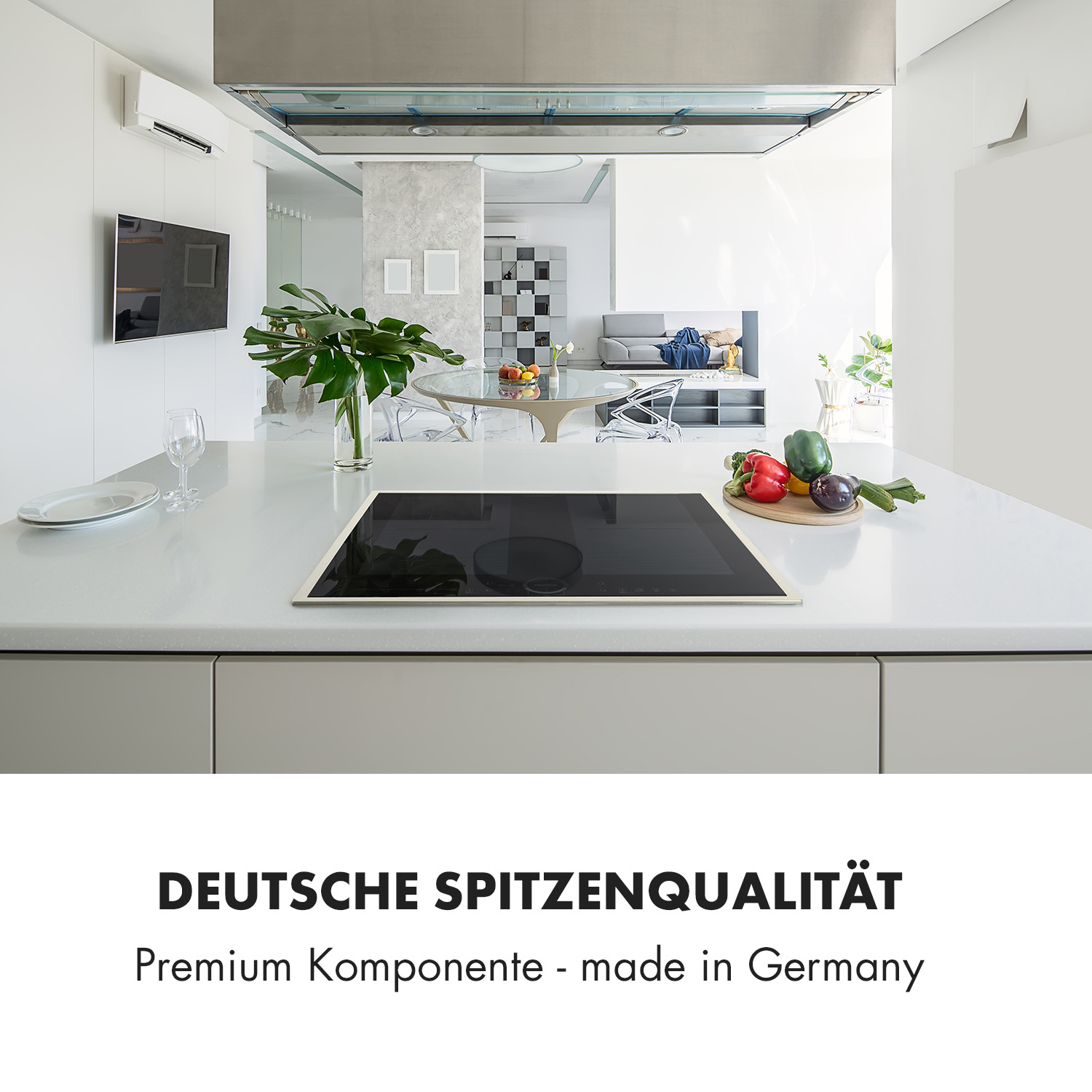 Cocina moderna con encimera blanca, placa de inducción y productos frescos.