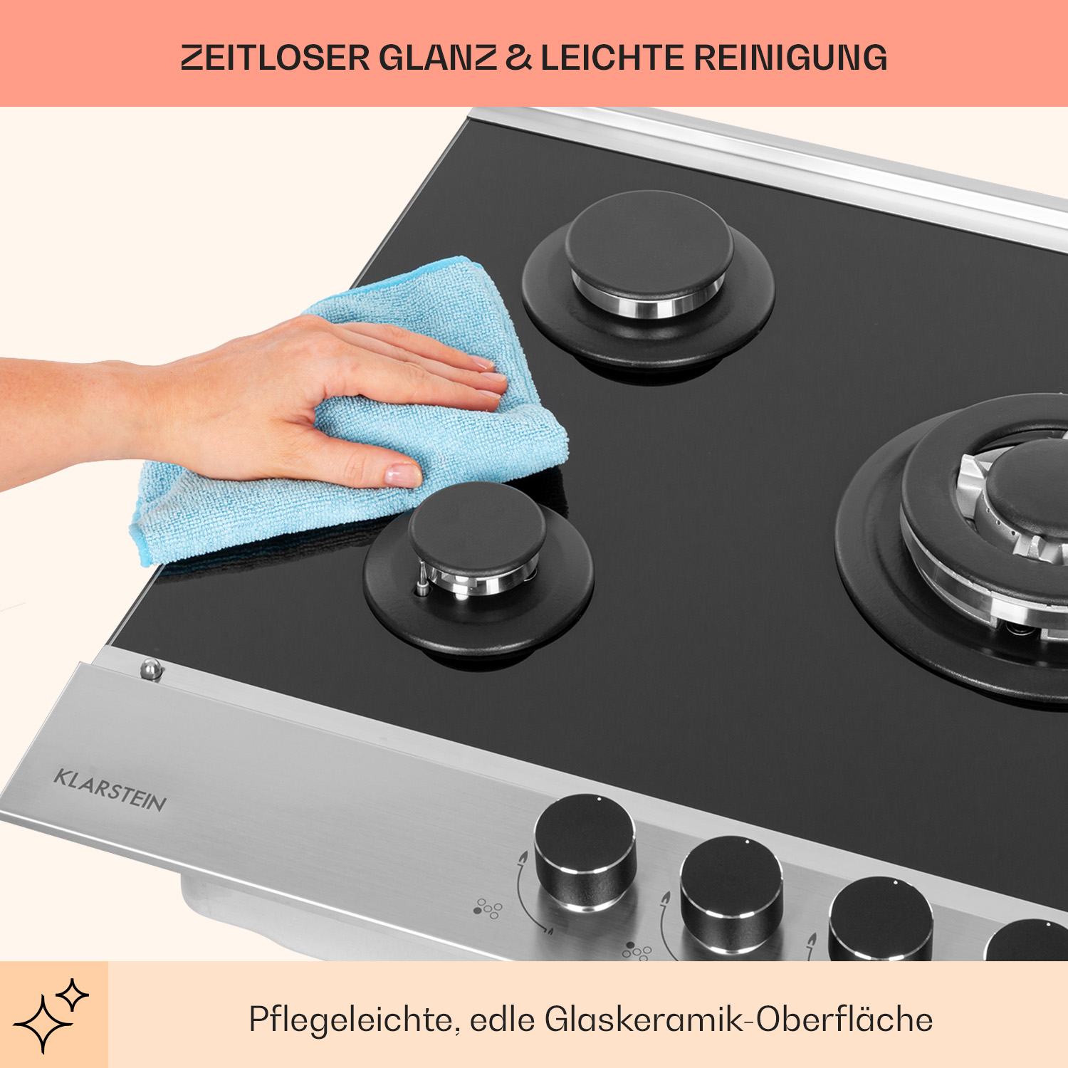 Schwarzes Glaskeramik-Kochfeld mit drei Brennern, das mit einem blauen Tuch gereinigt wird.