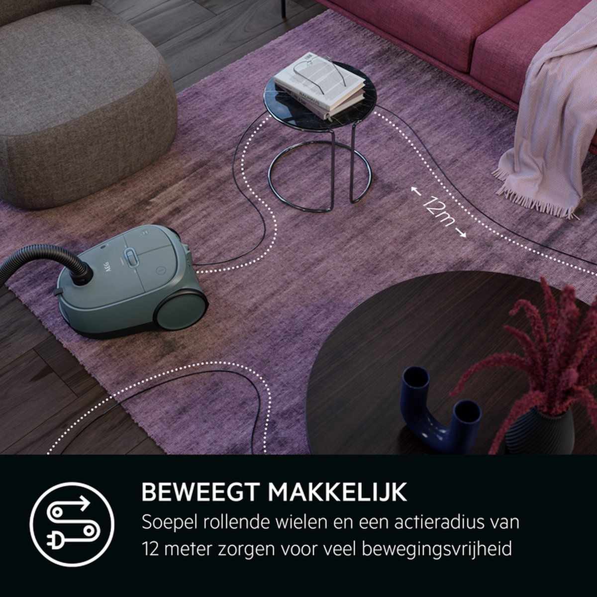 Stofzuiger op een paars tapijt, met een 12m snoer naar een tafel.