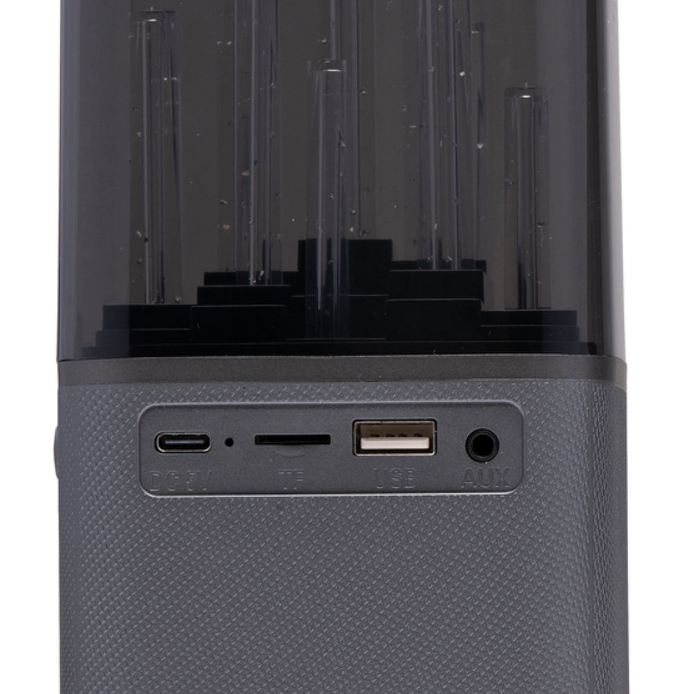 Een grijze luidspreker met USB, AUX en een oplaadpoort, met een transparante bovenkant.