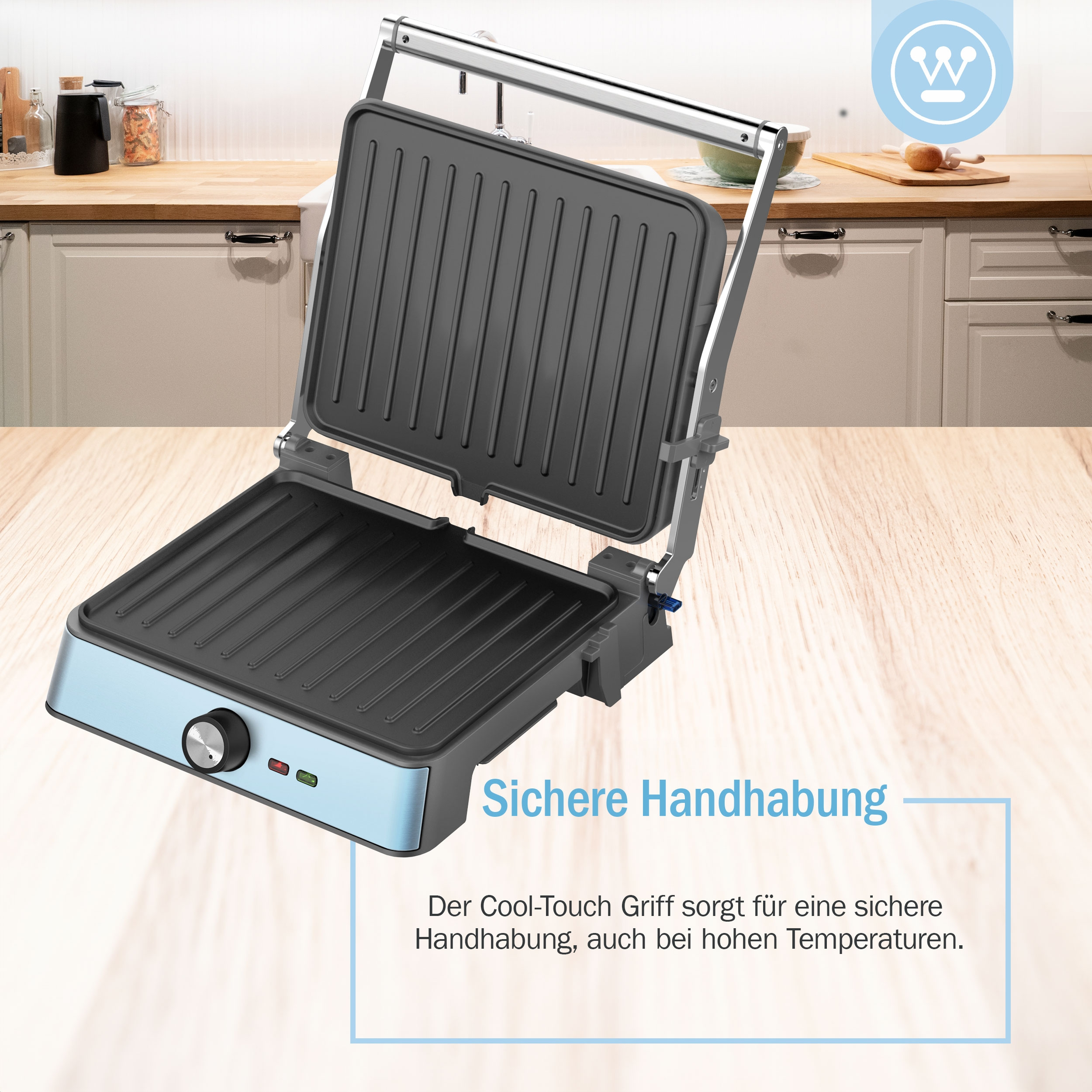 Offener Grill, blaue Basis, schwarze Grillfläche und Text über Cool-Touch-Griff.