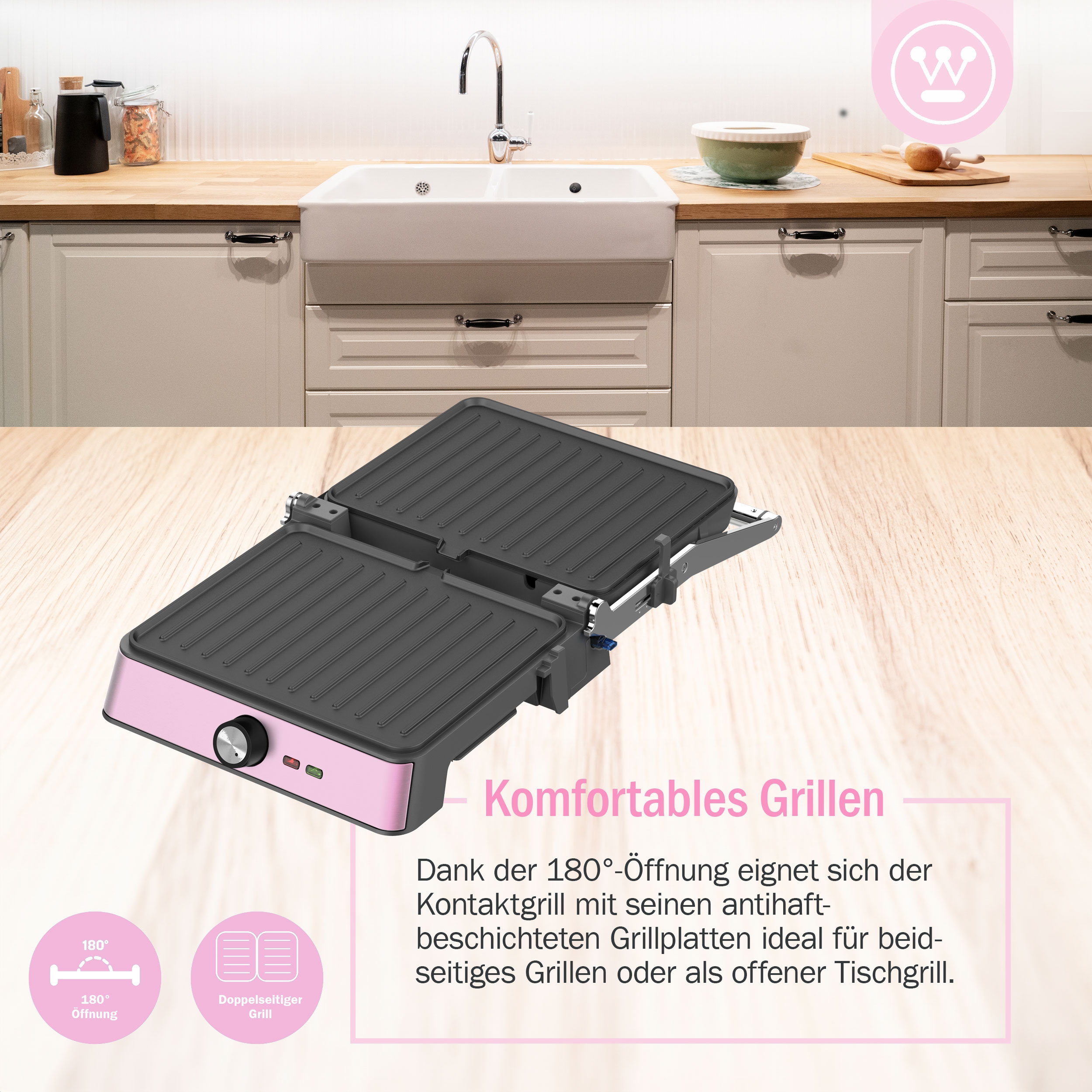 Rosa-schwarzer Kontaktgrill mit rosa Bedienknopf und Aufschrift: "Komfortables Grillen". Küche im Hintergrund.