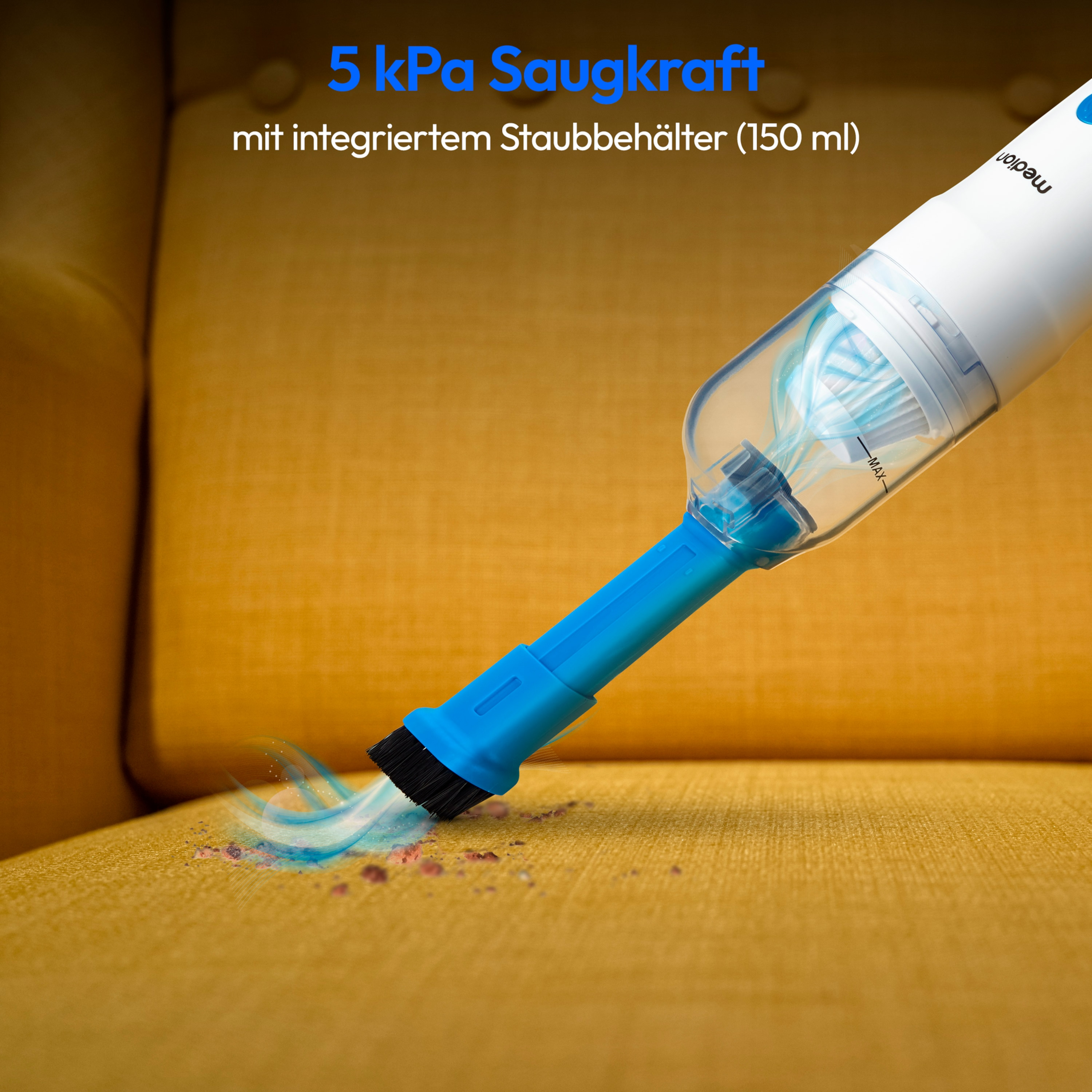 Handheld vacuum cleaning a yellow sofa, showing suction and dust removal.