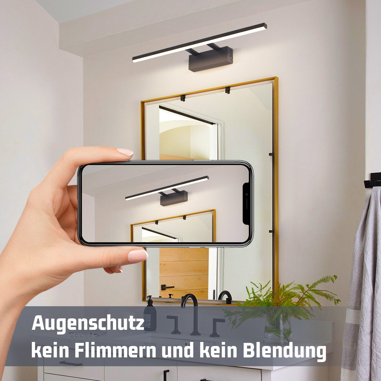 Una persona scatta una foto di uno specchio da bagno moderno con uno smartphone.