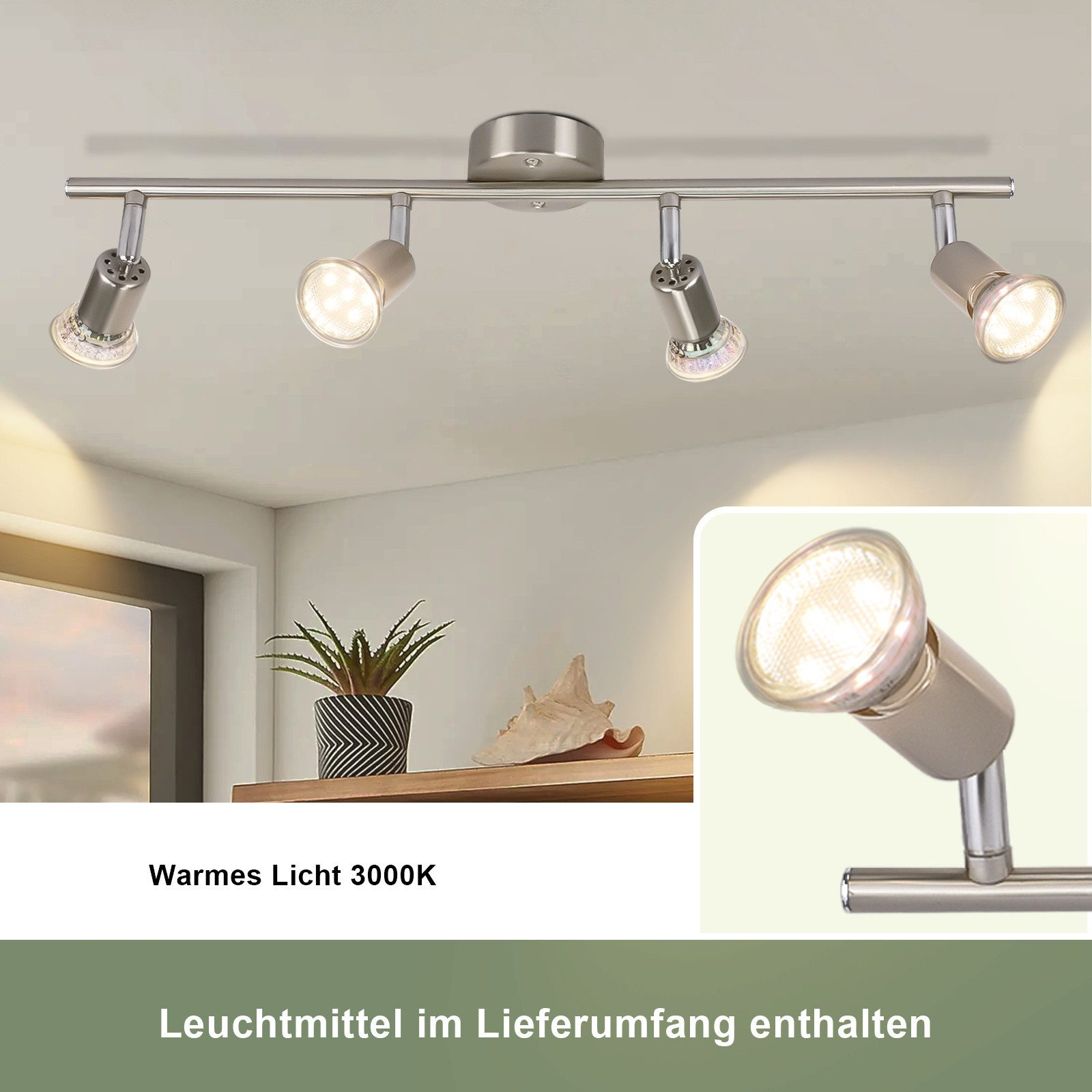 Srebrna lampa szynowa z 4 światłami, półka z rośliną i muszlą przed białą ścianą.