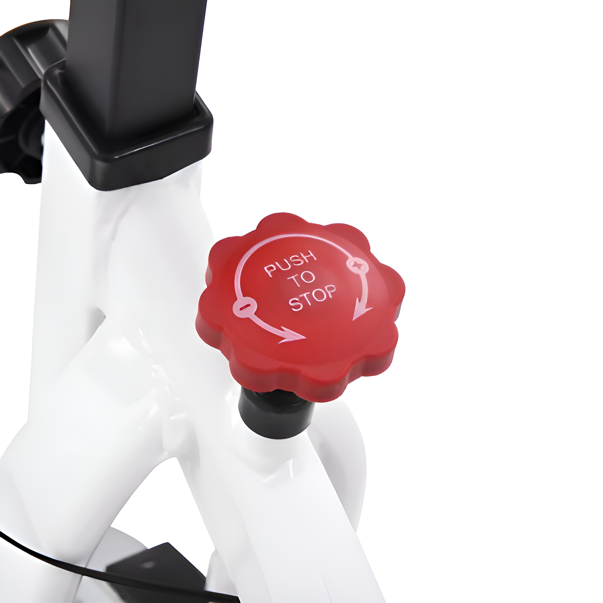 Ein roter Knopf mit dem Text "PUSH TO STOP" auf einem weißen Heimtrainer.