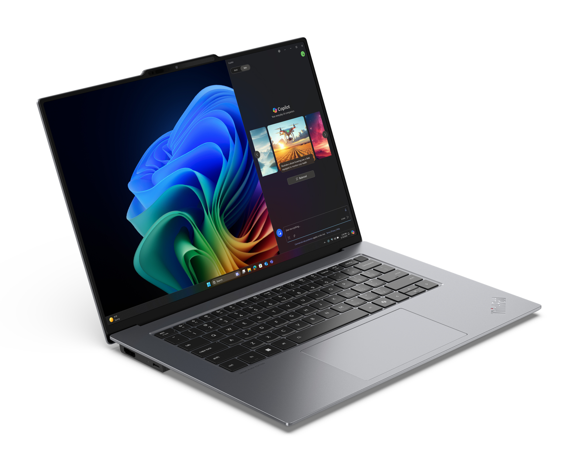 Laptop z kolorowym tłem na ekranie otwarty w jasnym otoczeniu.